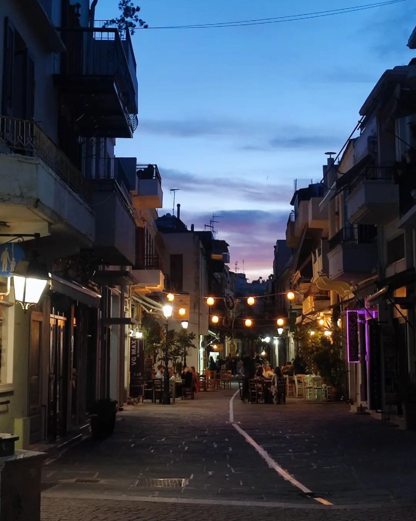 Beautiful purple and blue sunset sky on a cozy little street in Old town Rethymno