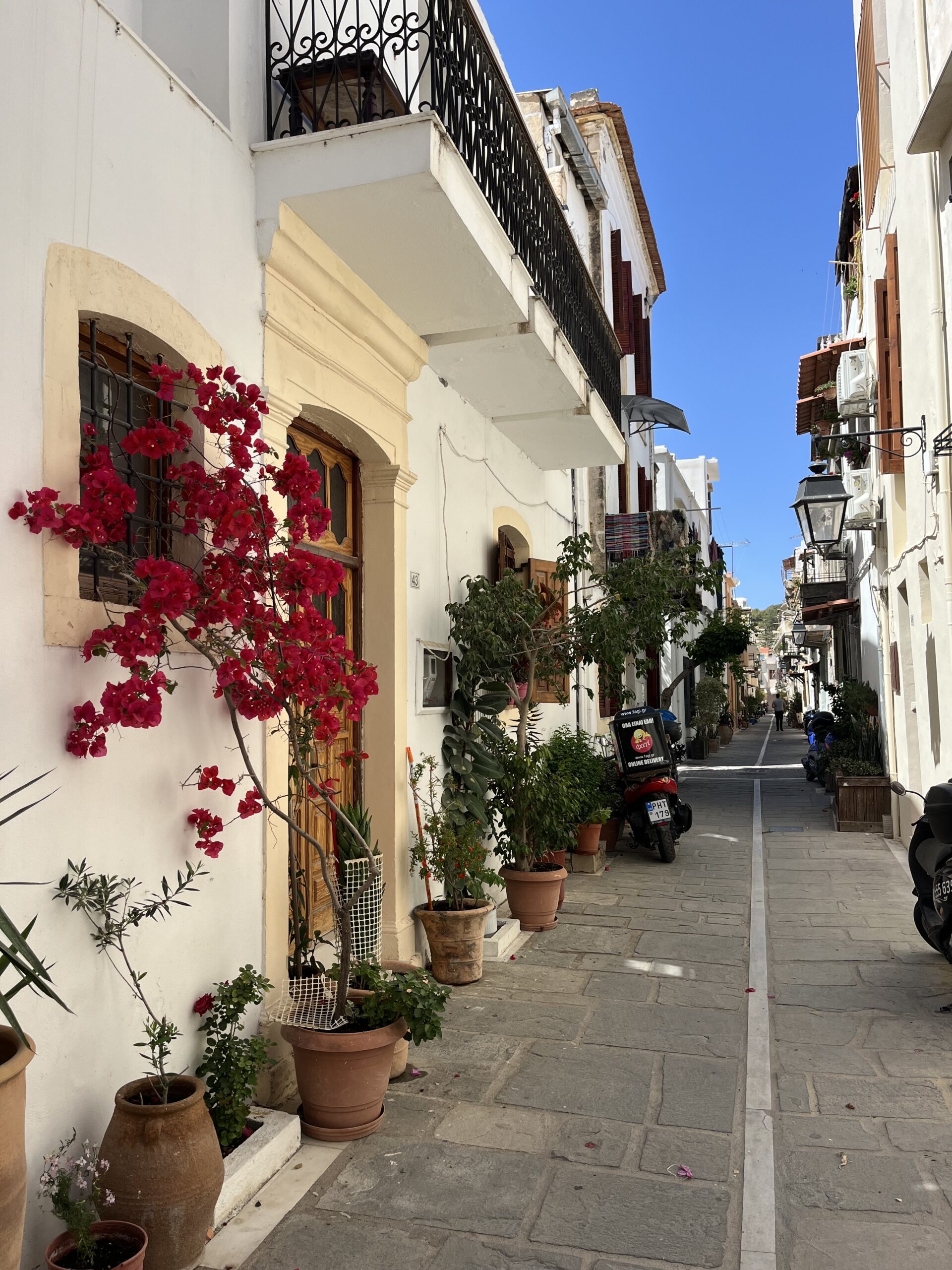 View of a home in Rethymno Old town with pink lowers and flower pots