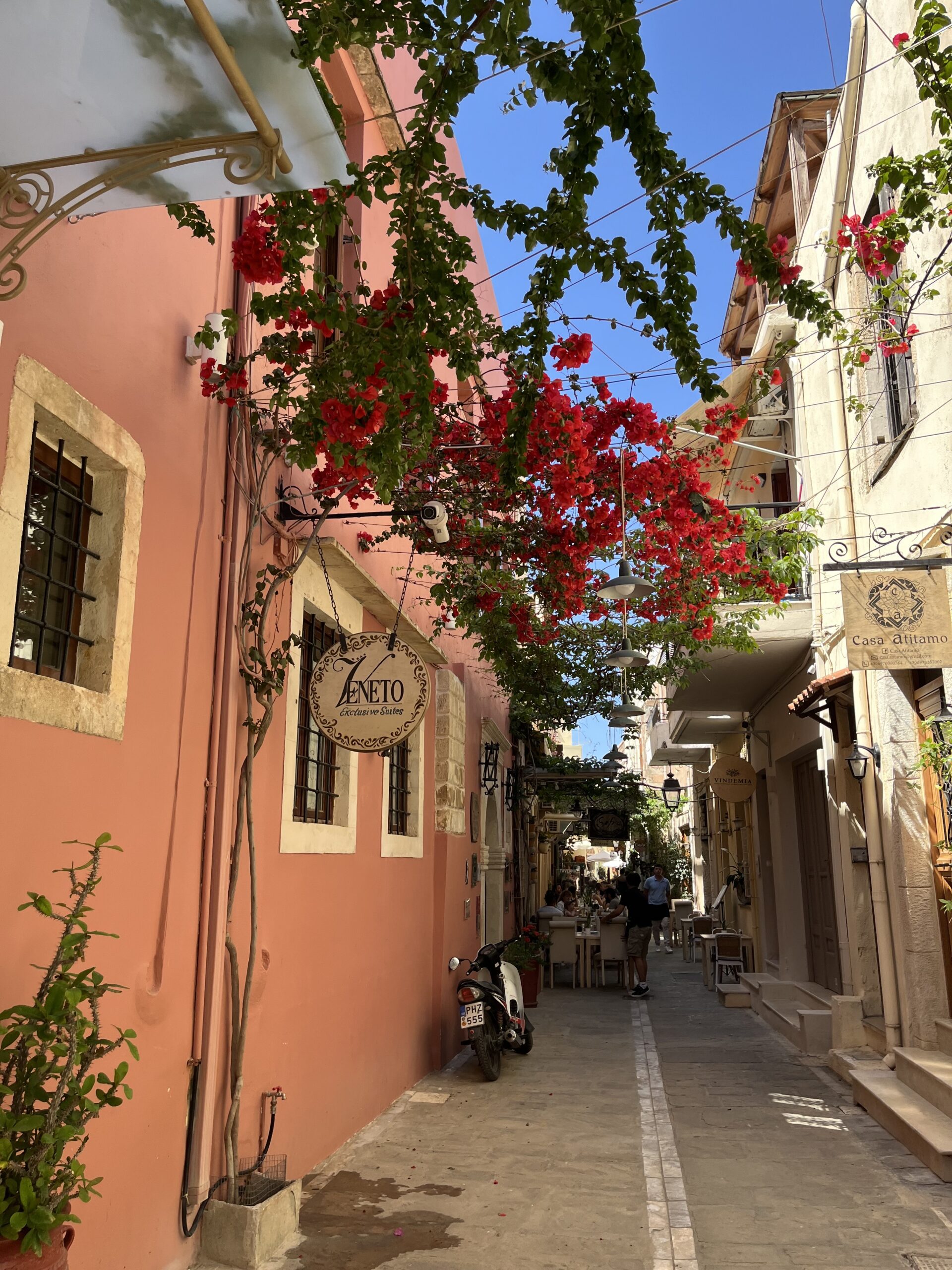 pink building with pink flowers in narrow street Old Town Rethymno Crete on a beautiful sunny day