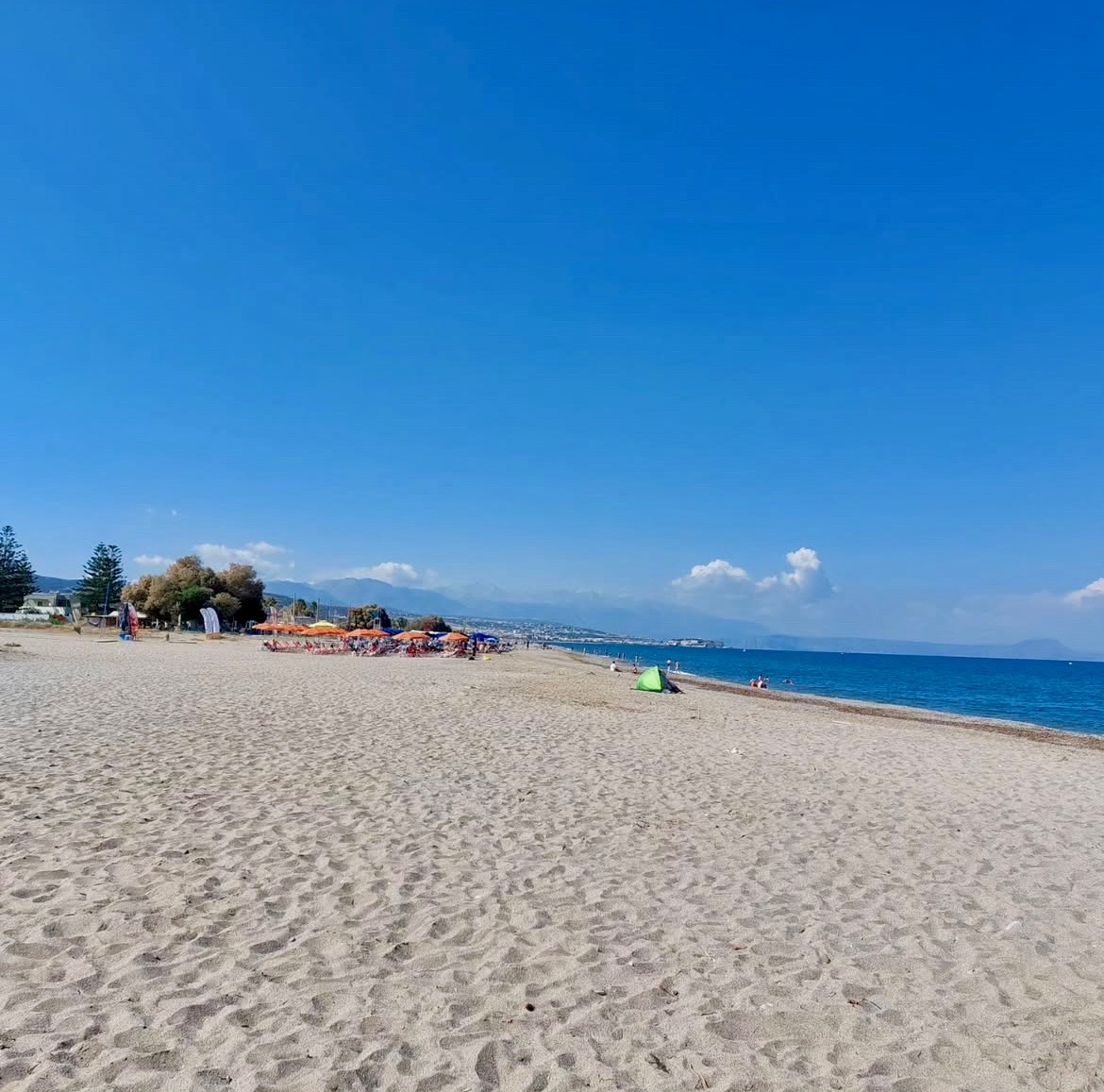 Families and visitors enjoying Platanes Beach in Rethymno Crete