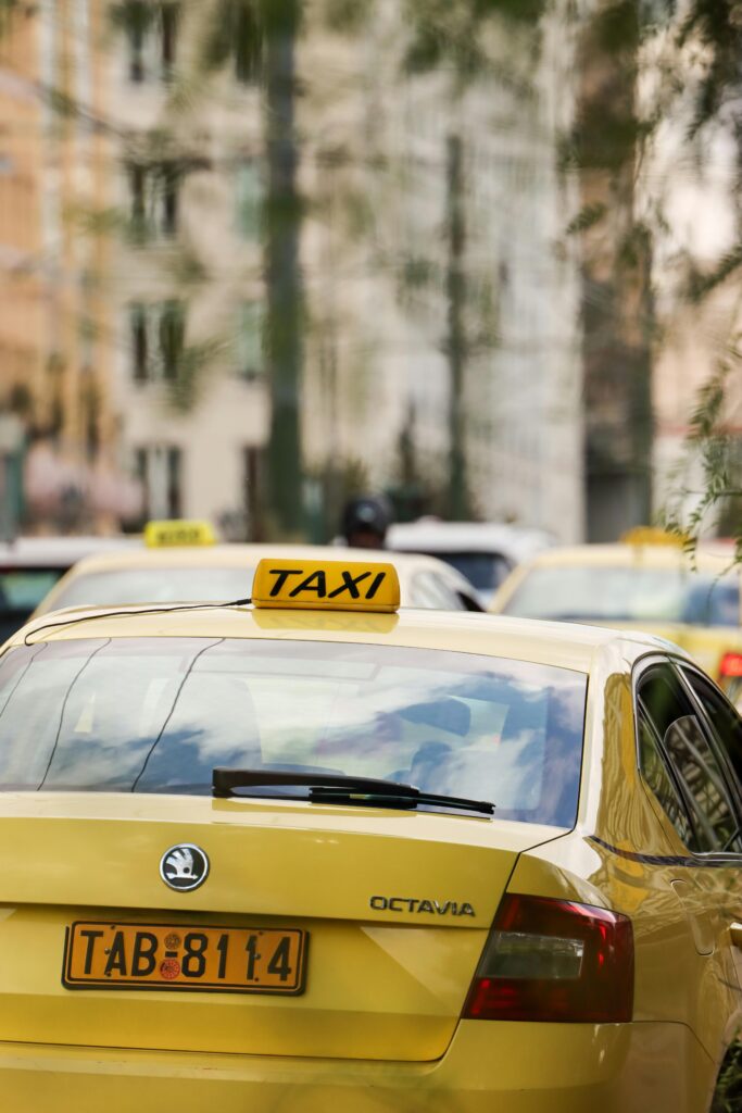 A busy street filled with yellow taxis in Athens, Greece, showcasing urban life.