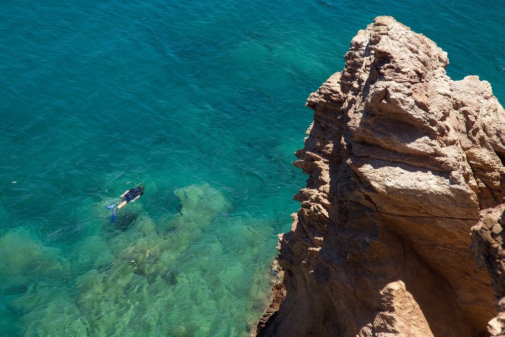 Snorkeling in Rethymno Crete with clear turquoise water and rocky coastline